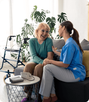 Elderly woman and caregiver smiling together.